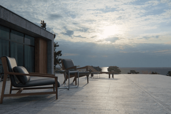 A serene outdoor patio at dusk, featuring minimalist wooden chairs with dark cushions. The expansive patio overlooks a body of water with a soft, setting sun partially covered by clouds, casting a calm atmosphere. The modern building in the background has large, tinted windows reflecting the natural light.