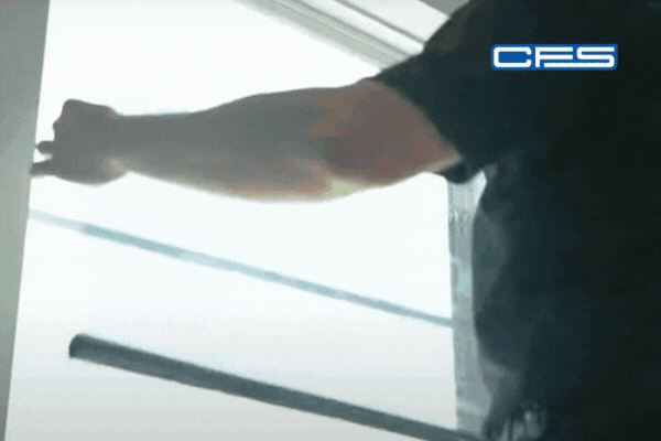 Animated clip of a certified installer carefully applying window film to a large glass window using precision tools, with the “CFS” logo in the top right corner, emphasizing the clean, expert finish that distinguishes professional work from DIY attempts.
