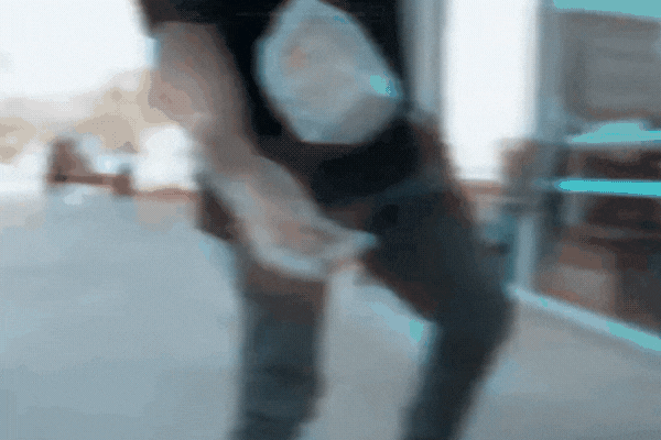 A slow-motion clip shows a person throwing a heavy object directly at a large glass window, which shakes but does not shatter, demonstrating the strength and impact resistance of a security window film.