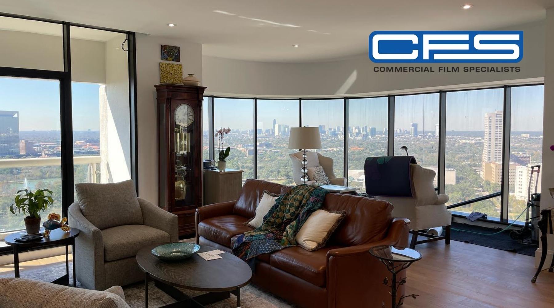 High-rise Houston living room with panoramic UV-protected windows tinted by Commercial Film Specialists