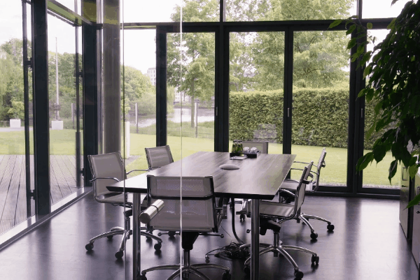 Modern glass-walled conference room with window film, showcasing clear outdoor visibility, natural light, and enhanced privacy.