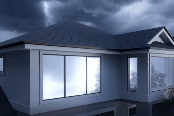 Modern Houston home with large windows under dark storm clouds before a hurricane