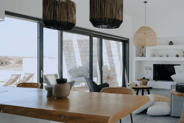Modern living room with large sliding glass doors demonstrating the energy-saving and heat-reducing benefits of residential window tinting.